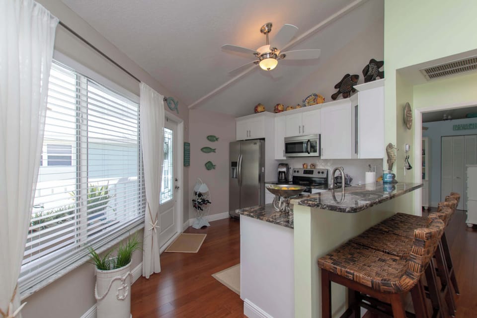 Kitchen features a breakfast bar with seating for 4
