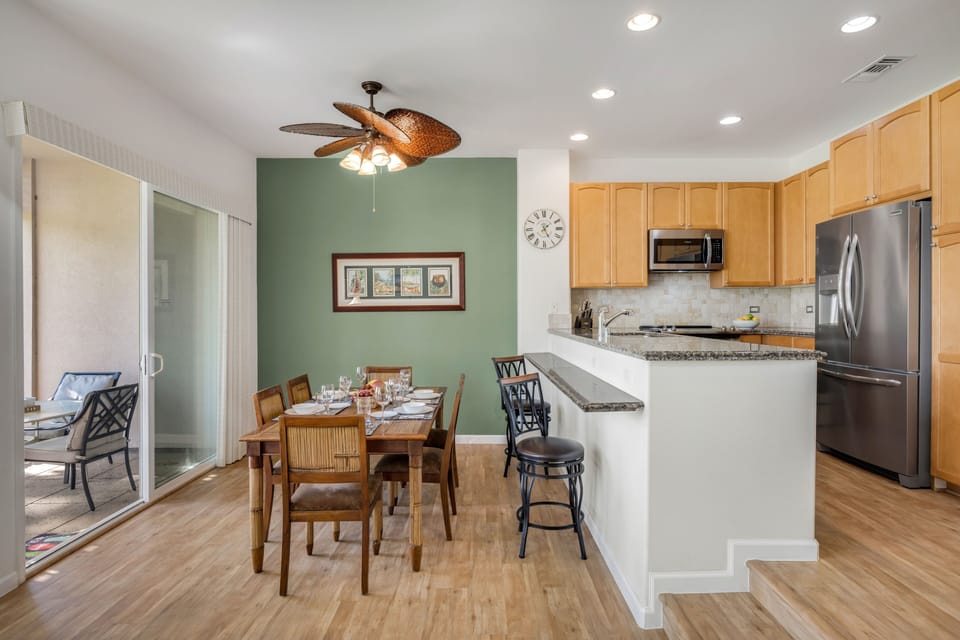 This fully equipped kitchen with granite countertops opens to the dining area, offering form, function, and flow.