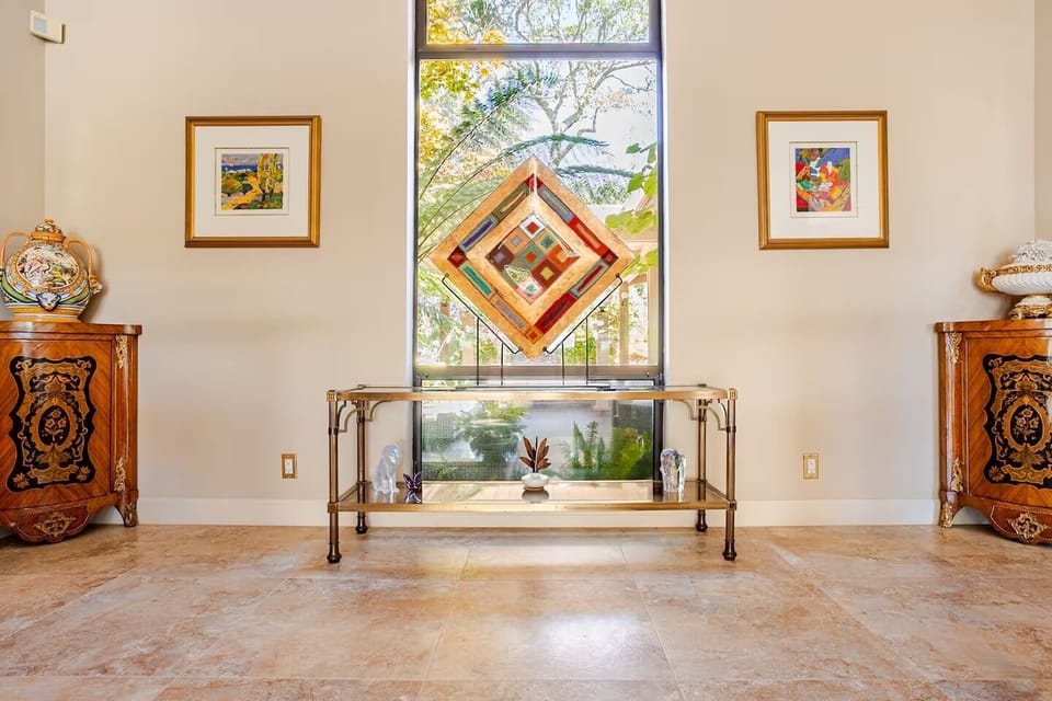 Foyer entry area overlooking exterior courtyard with fountain.