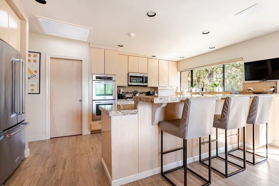 Kitchen with counter seating and TV.
