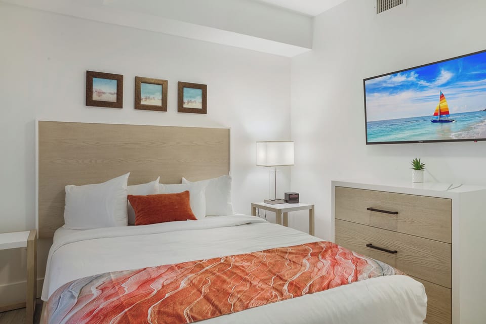 Guest Bedroom with Cable TV, Dresser and Closet.