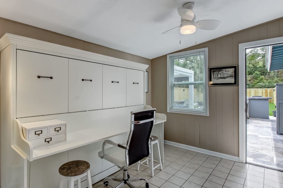 Office desk/queen Murphy bed.  Door opens to backyard, pool & patio