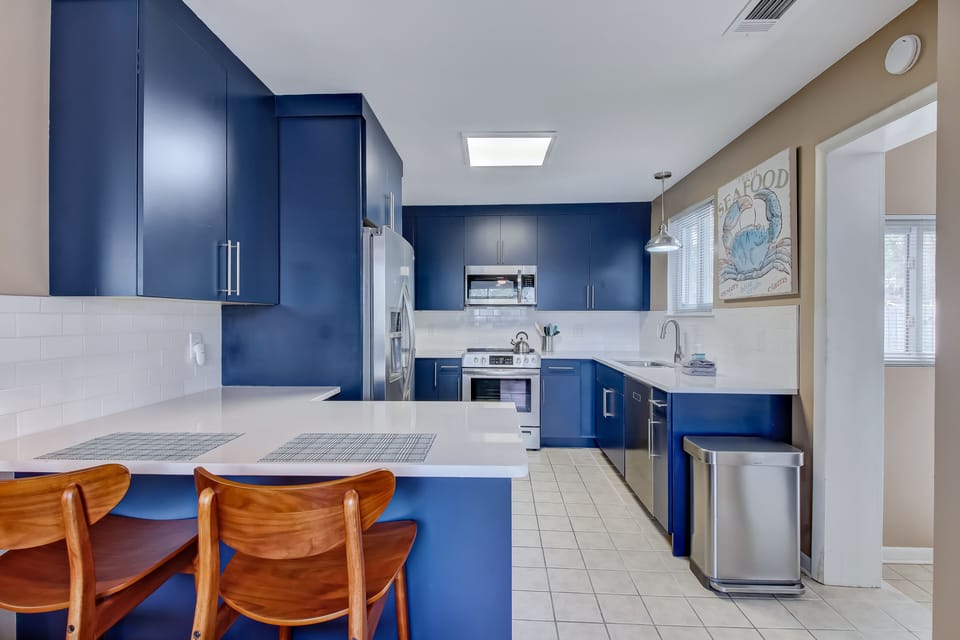 Brand new kitchen with refrigerator, microwave, dishwasher and bar seating