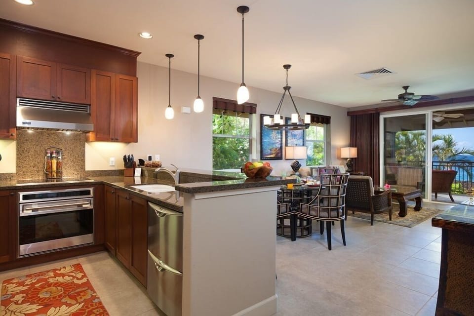 Full kitchen with stainless steel appliances, granite countertops, and breakfast bar