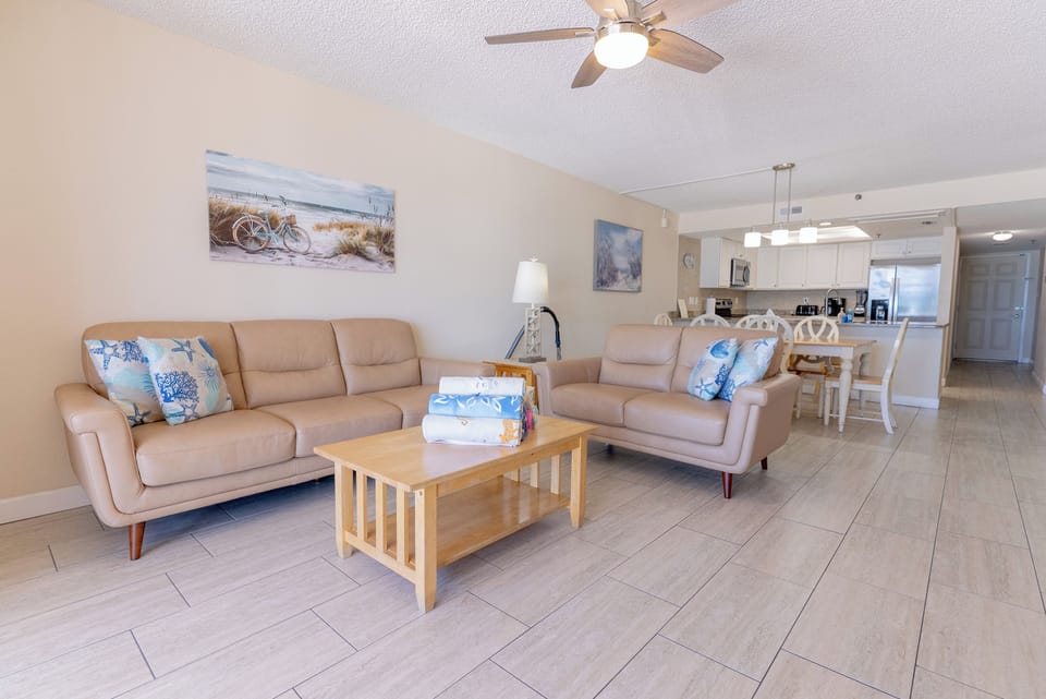 Living room what’s plenty of furniture flatscreen TV? Overlooking the ocean.
