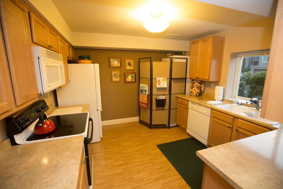 Complete kitchen. Clothes washer and dryer are behind the screen. 