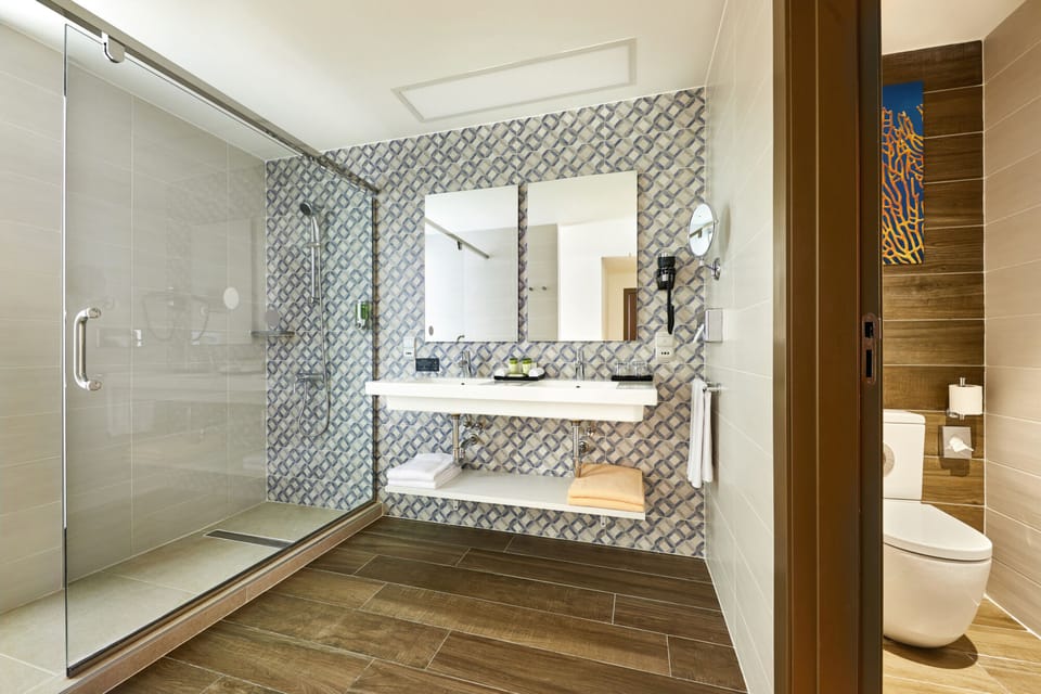 Designer toiletries, hair dryer, slippers, towels