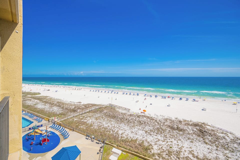 Children's laughter bubbles from the splash pad as you gaze out over the white beach and turquoise coast below