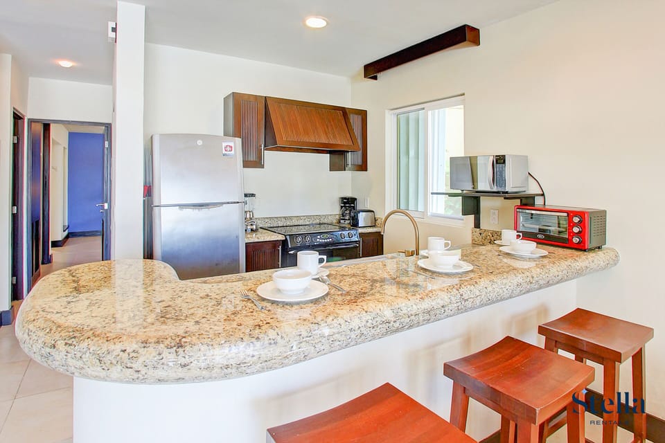 Deluxe Apartment, Kitchen, Pool View | Private kitchen | Full-size fridge, microwave, oven, stovetop