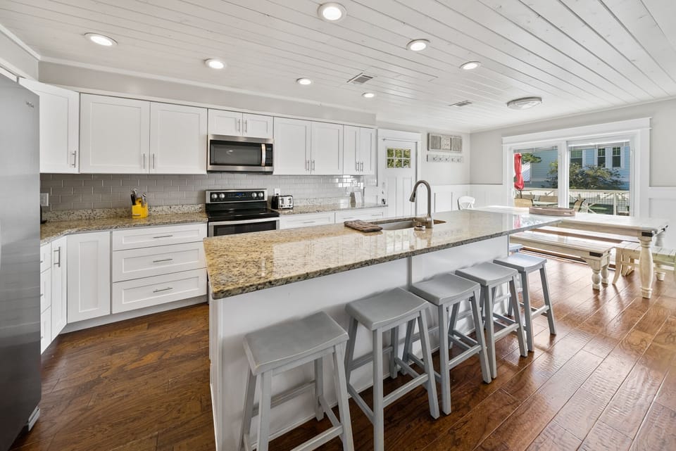 Cook memorable meals in your bright, modern kitchen featuring granite counters and island seating for gathering.