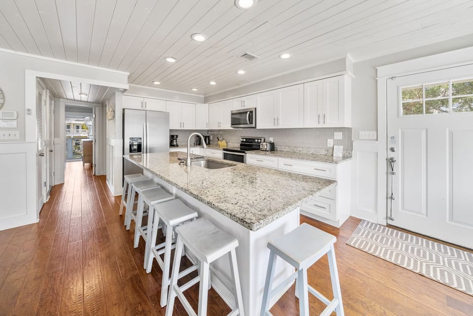 Your spacious kitchen features granite countertops, stainless appliances, and a breakfast island where you'll gather for morning coffee and evening conversations.
