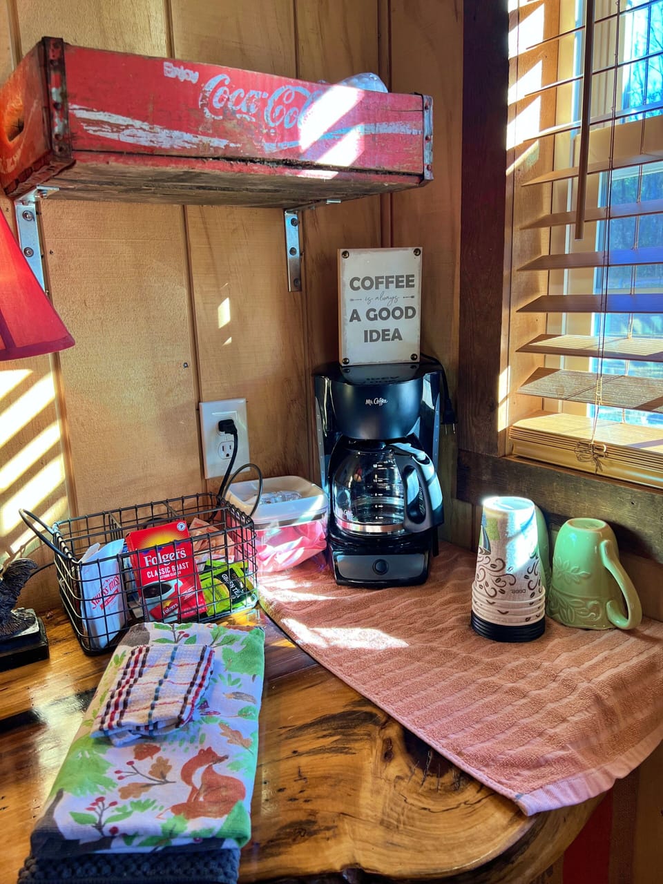 Drip coffee pot with coffee, sugar/sweetener, cream provided.