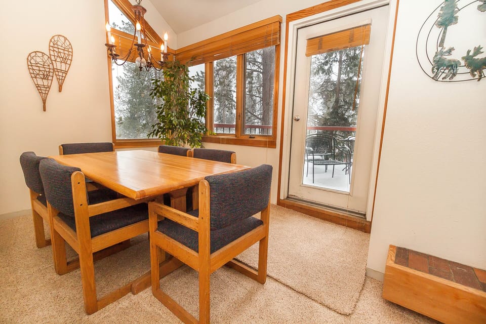 Gather around your warm wood dining table with mountain views through picture windows, perfect for memorable meals together.