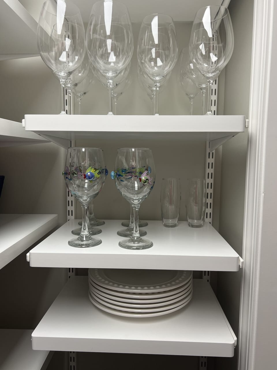 Wine glasses and extra plates in pantry