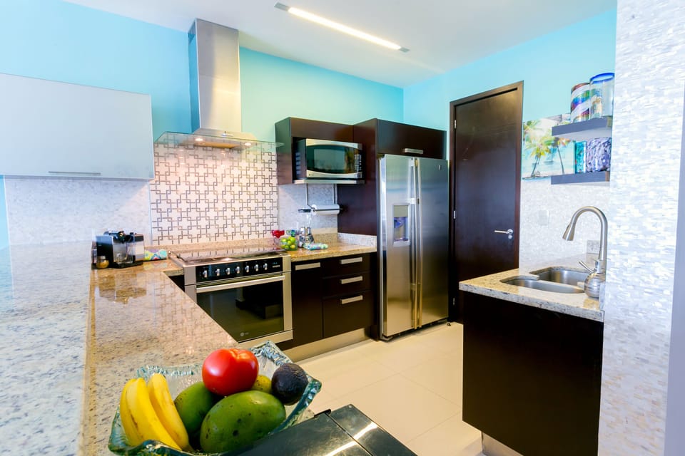 Kitchen on main floor with American style appliances including dishwasher 