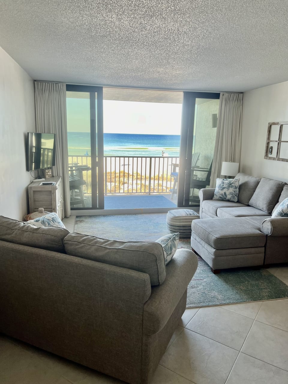 Living room with access to balcony showing sofa and loveseat.