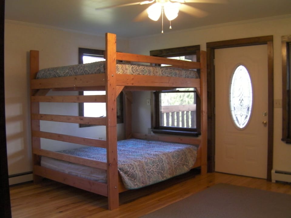 Master bedroom has a queen bunk bed and a twin bed with attached bathroom