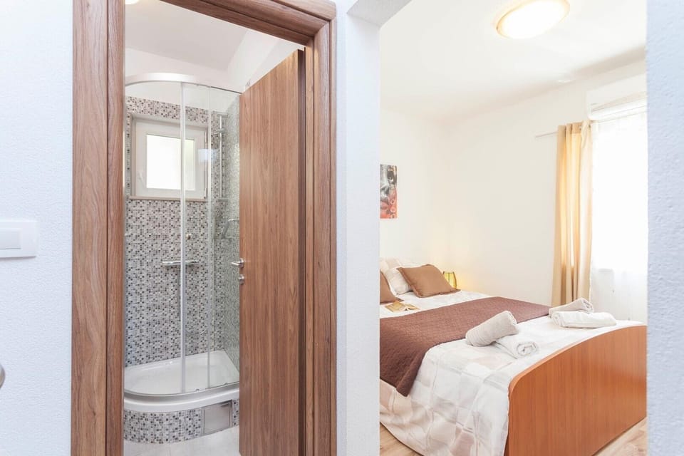 Air-conditioned bedroom with a TV