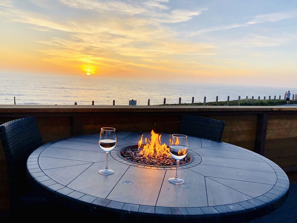 Fire table and chairs on the deck with sunset view
