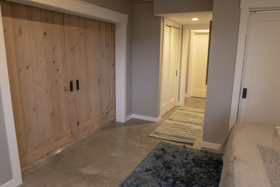 Alder would barn doors provide separation from living space and kitchen.