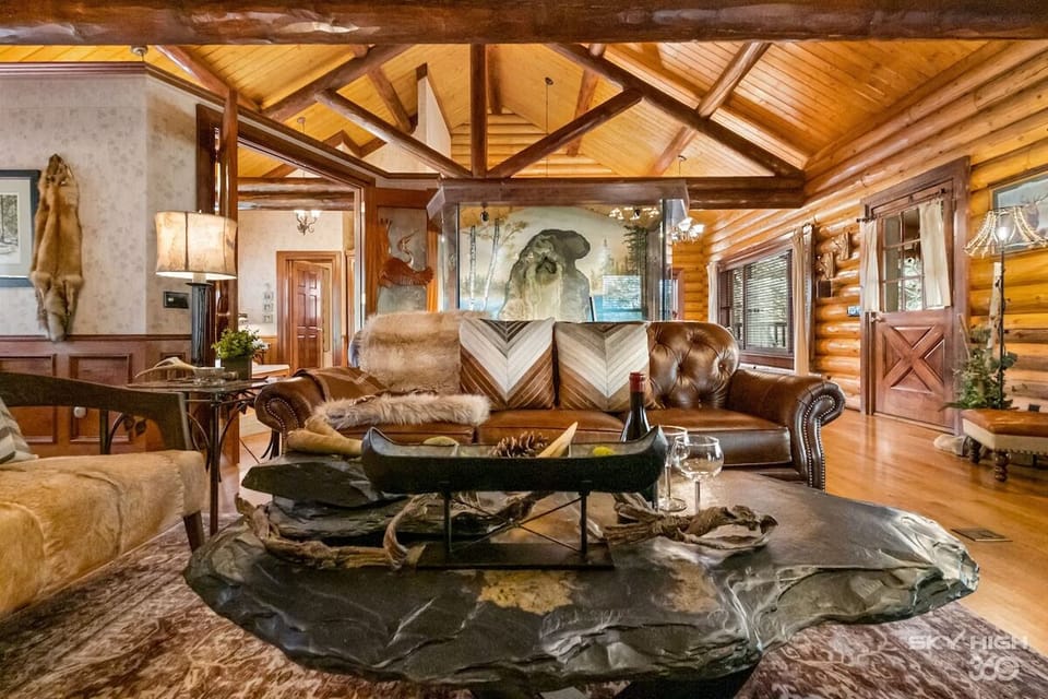 View of the encased indoor waterfall behind the plush leather couch.