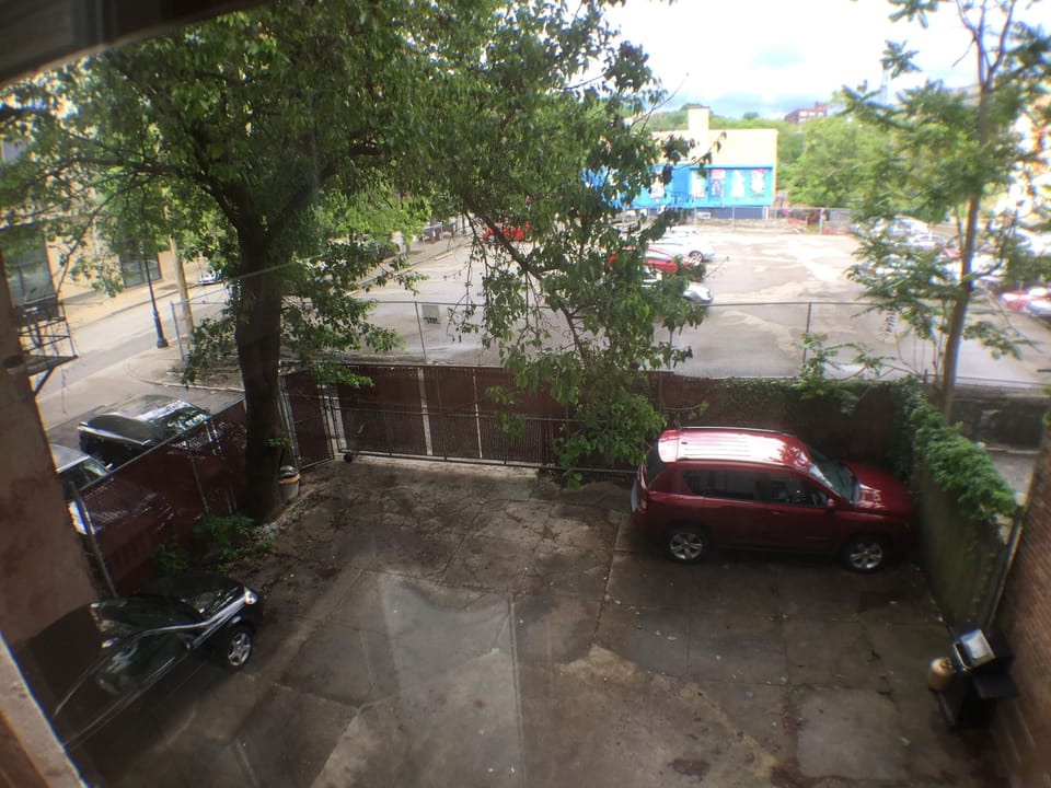 There is an off street, secure fenced parking spot for you (where red car is)