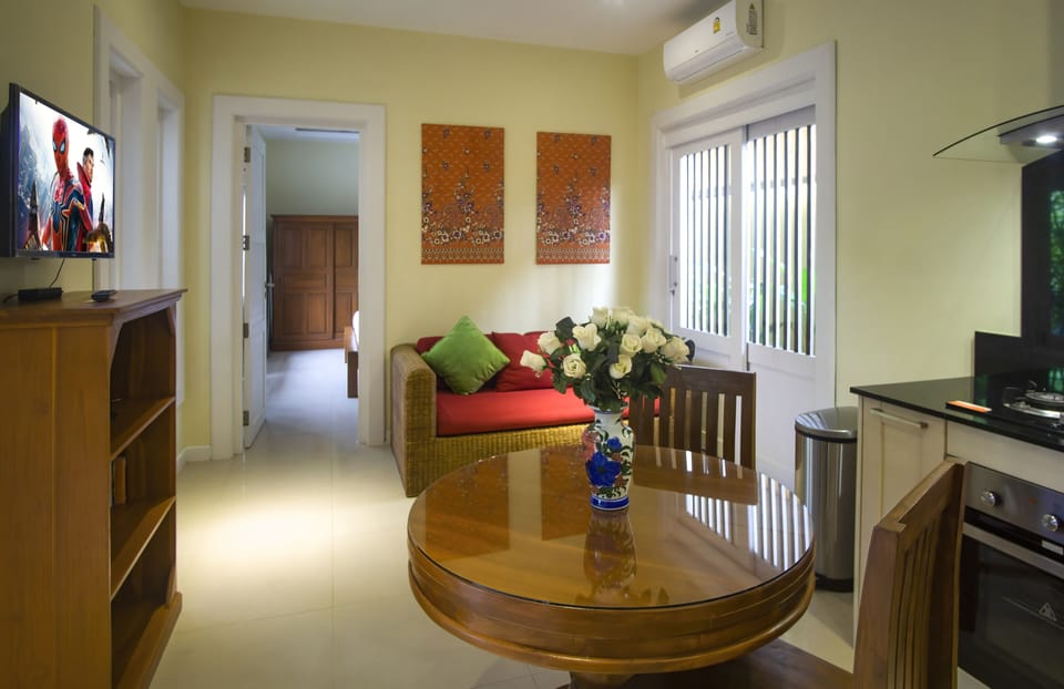 Air-conditioned living area has SMART TV with Netflix & Youtube & dining table 