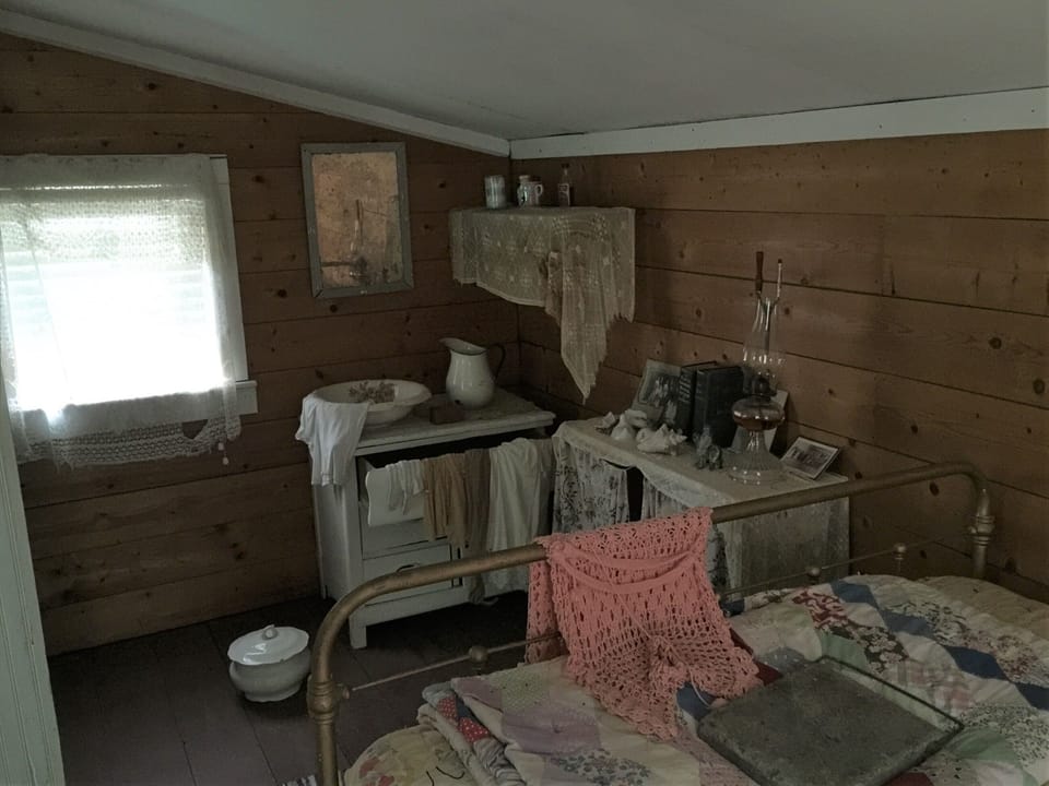 Homestead bedroom. Pitcher and bowl. Thunder pot. Curling iron. 