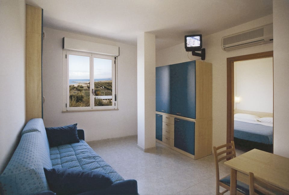 Standard Apartment | Living area | 36-inch TV with digital channels