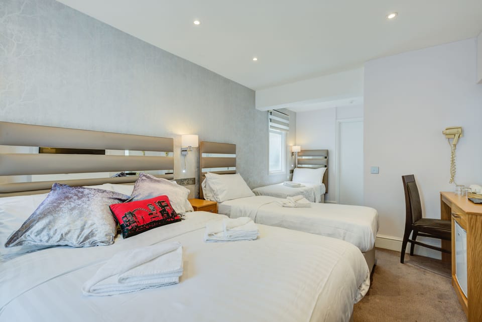 Quadruple Room | Desk, blackout drapes, iron/ironing board, free WiFi