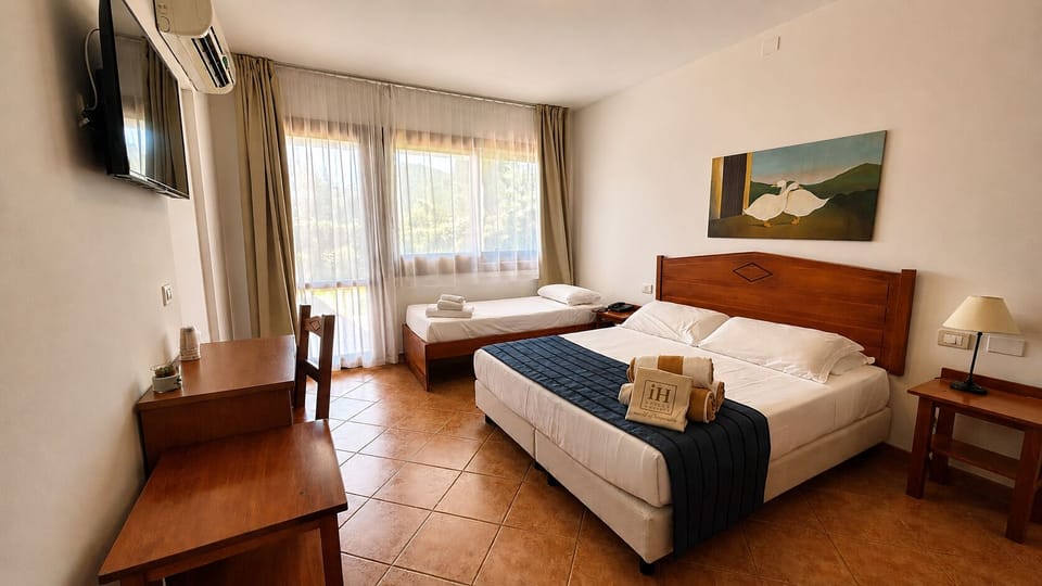 Standard Triple Room | Minibar, in-room safe, desk, soundproofing