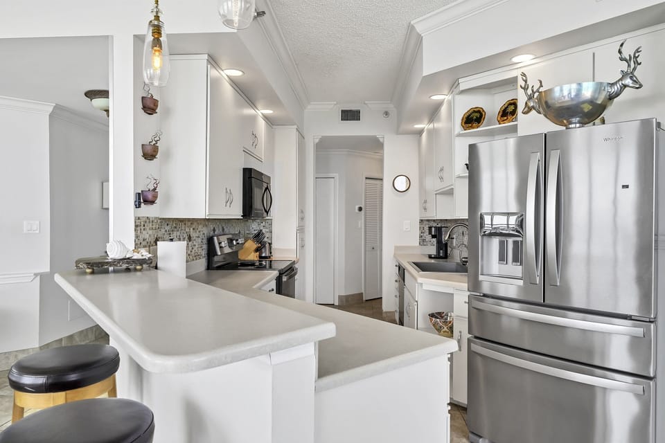 Kitchen has both a large pantry and plenty of cabinets for storage.