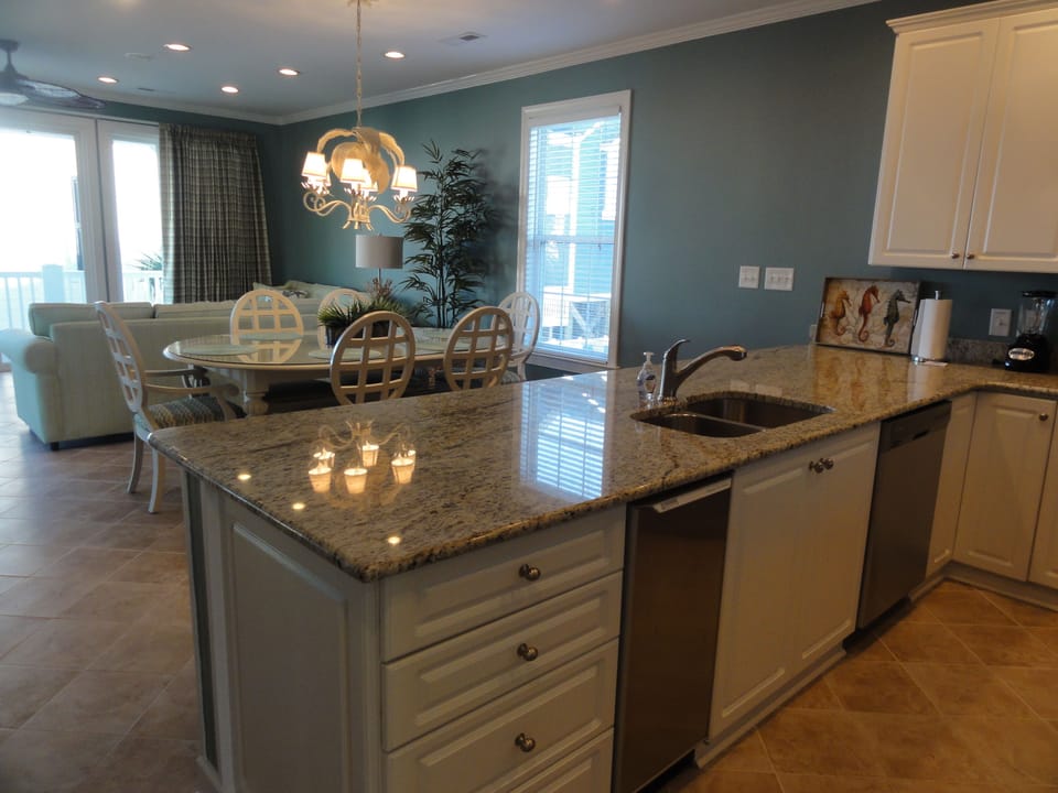 A cook's kitchen with every gadget imaginable to enjoy dinners at home including a separate ice machine! The open concept allows the cook to visit with family and enjoy the ocean view while working! Extra table-height bar seating.