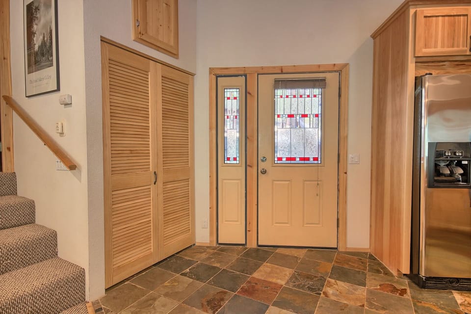 View towards front door and kitchen from living room