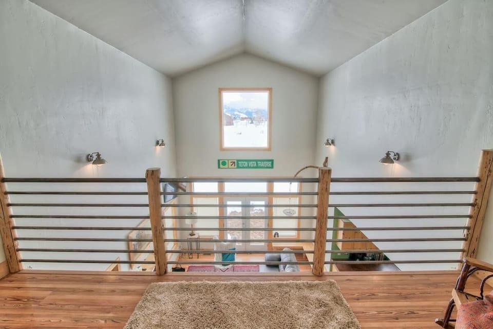 A view from the loft overlooking the living area and views.