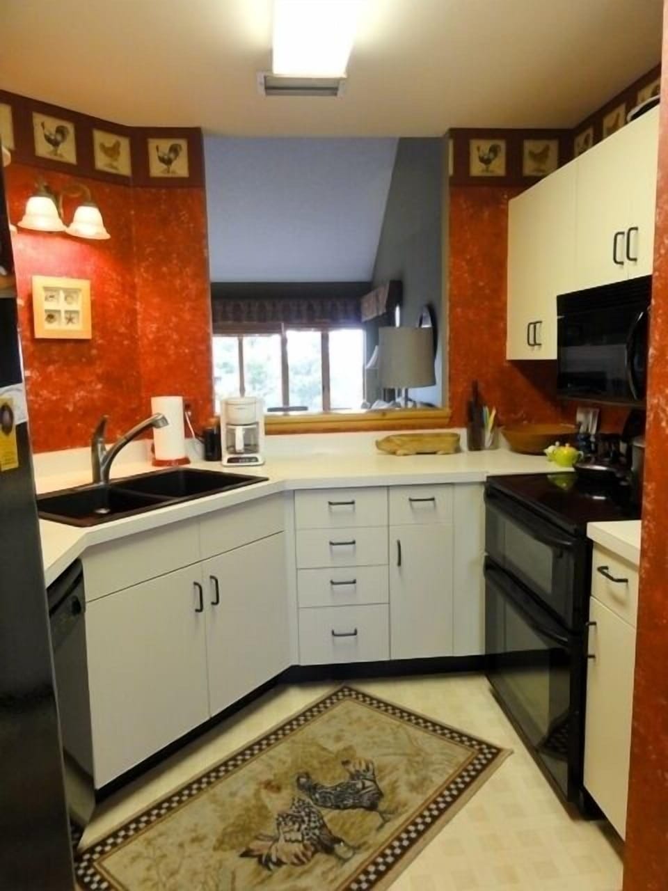 A sensible and well stocked kitchen.  Rooster motif.