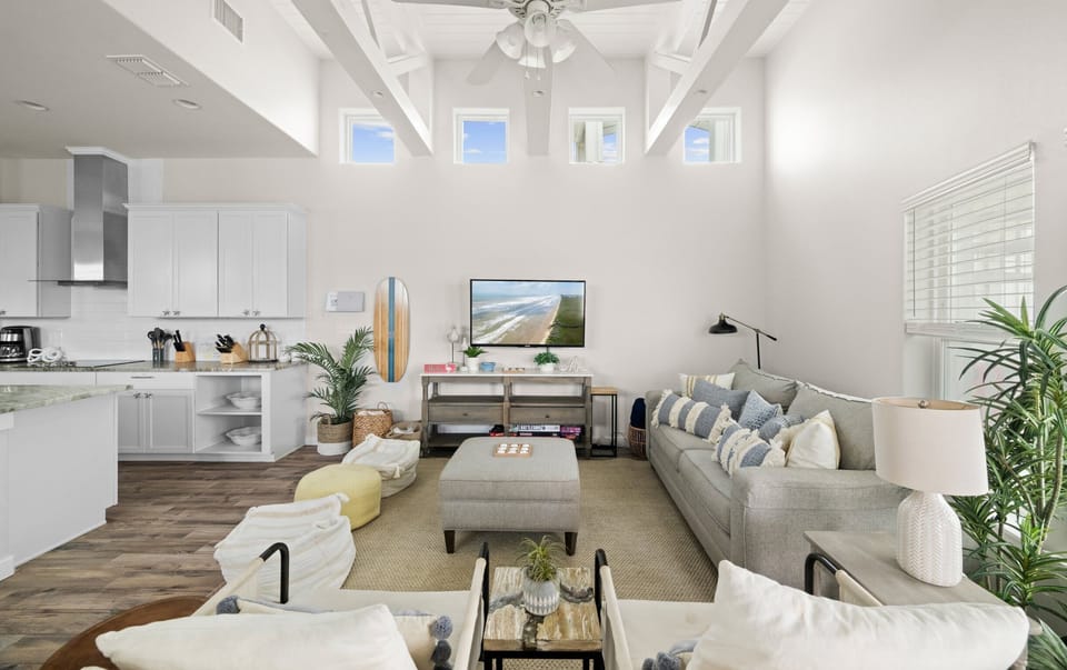 Living Room — Gray Sofa, Cream Chairs, Beach TV, Surfboard Decor, Exposed Beams & Clerestory Windows