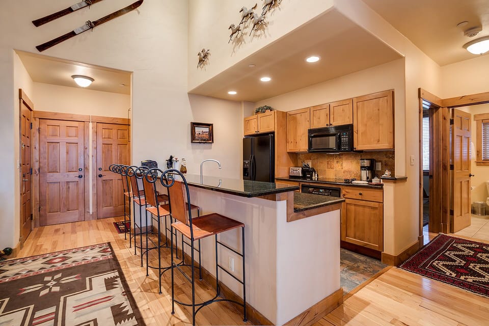 Gather around your spacious kitchen island for morning coffee or evening conversations, with premium appliances and warm wood finishes creating the perfect culinary retreat.