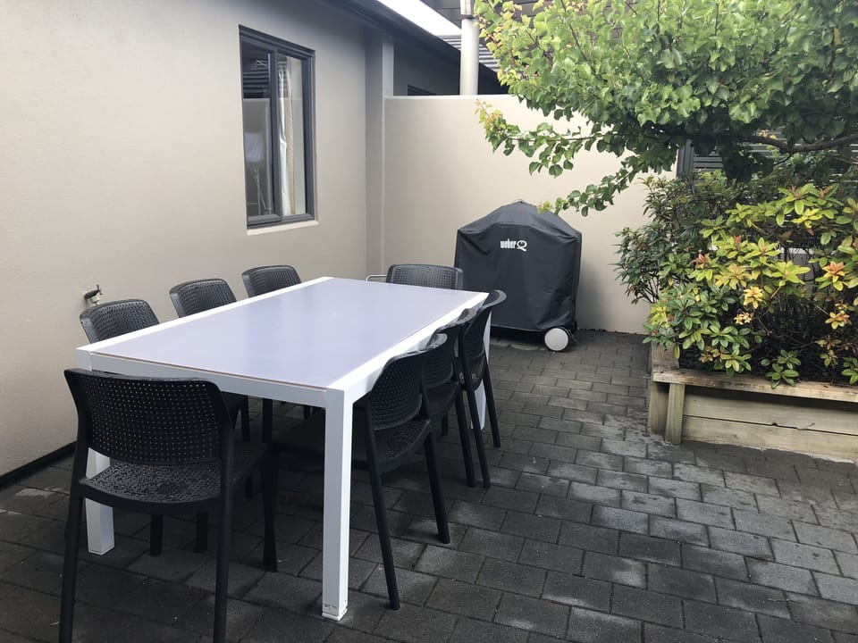 Outdoor patio with dining and Weber BBQ