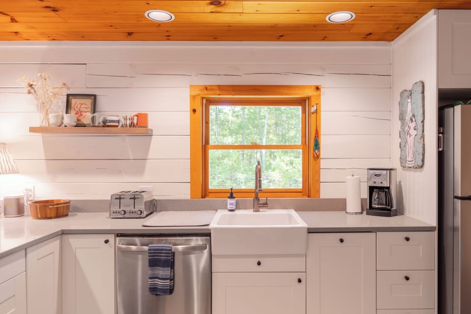 Kitchen with sink, dishwasher, and a lovely window view.