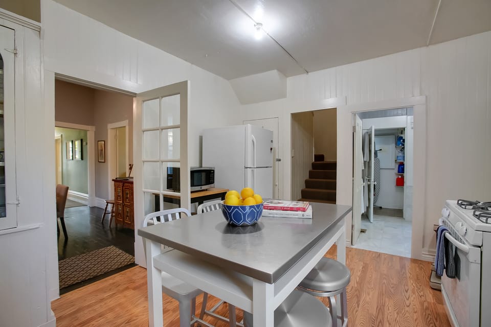 Kitchen looking towards bathroom 2 and laundry area~ and stairs to upstairs family suite