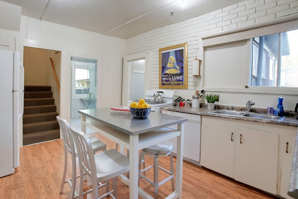 Kitchen looking towards bathroom 2 and laundry area~ and stairs to upstairs family suite