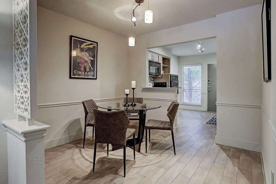 Elegant Dining glass table, ultra suede quilted chairs and chic designer lighting.
