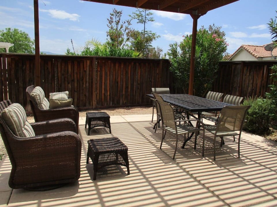 Covered patio w/ outdoor dining, sofa, etc. for enjoying the warm days and night