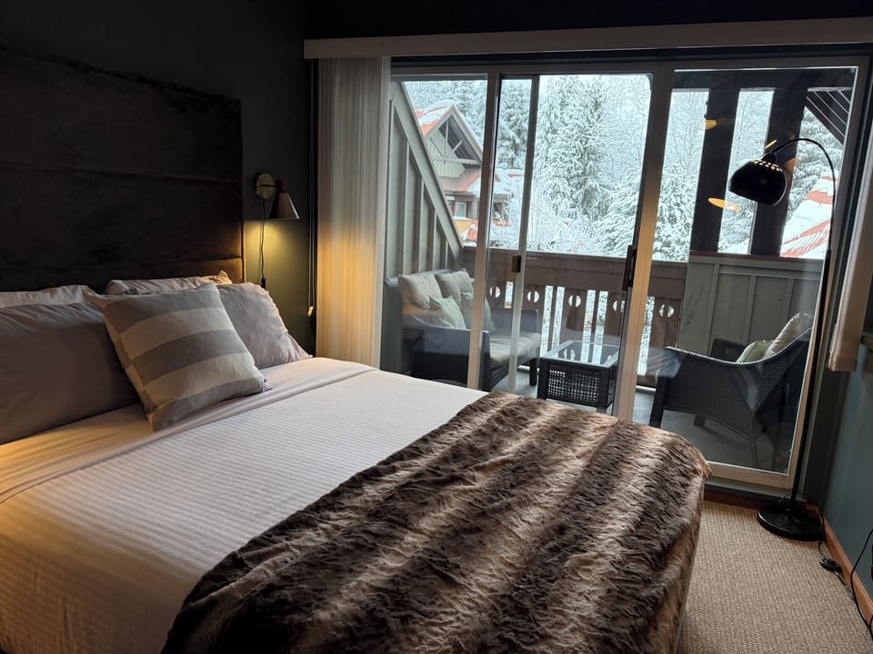 Master bedroom with patio seating that overlooks the pool and hot tub