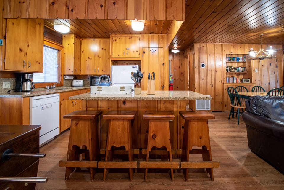 View of kitchen with 4 bar stools