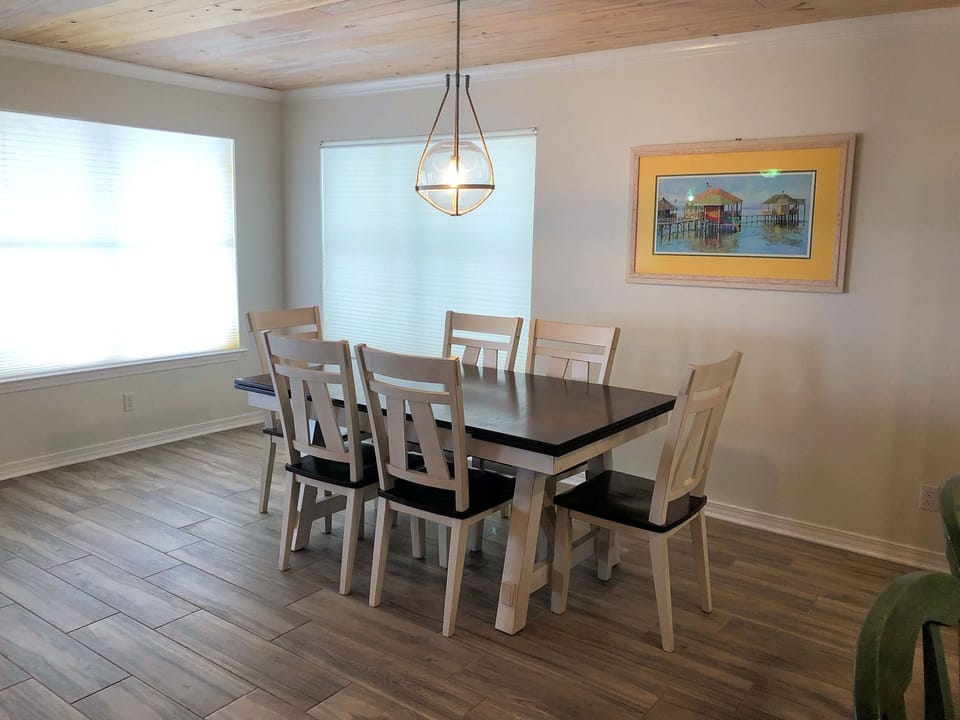 Gather around this spacious dining table where you'll create lasting memories over delicious meals with loved ones in this bright, welcoming space.