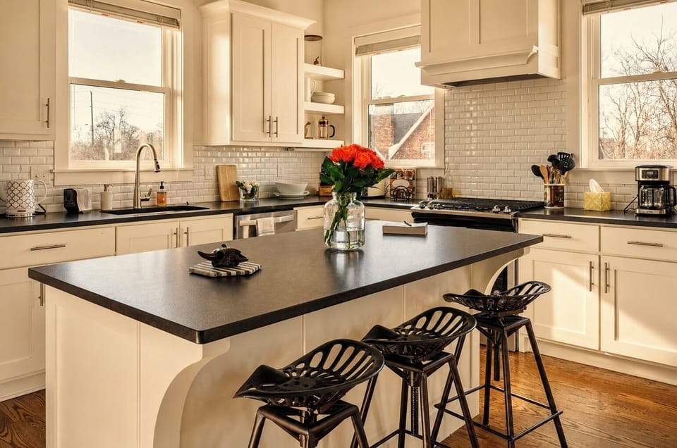 Bright modern kitchen with large island, bar seating, and natural light
