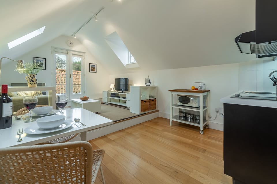 First floor:  The kitchen area features a dining table and chairs for two