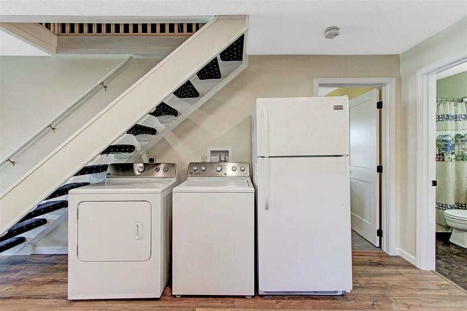 Washer / Dryer and Fridge with door to the right leading to Master bedroom
